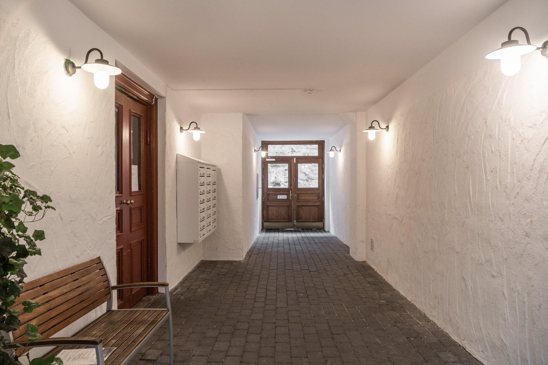 Nyrenoverad portgång med vitslammade väggar